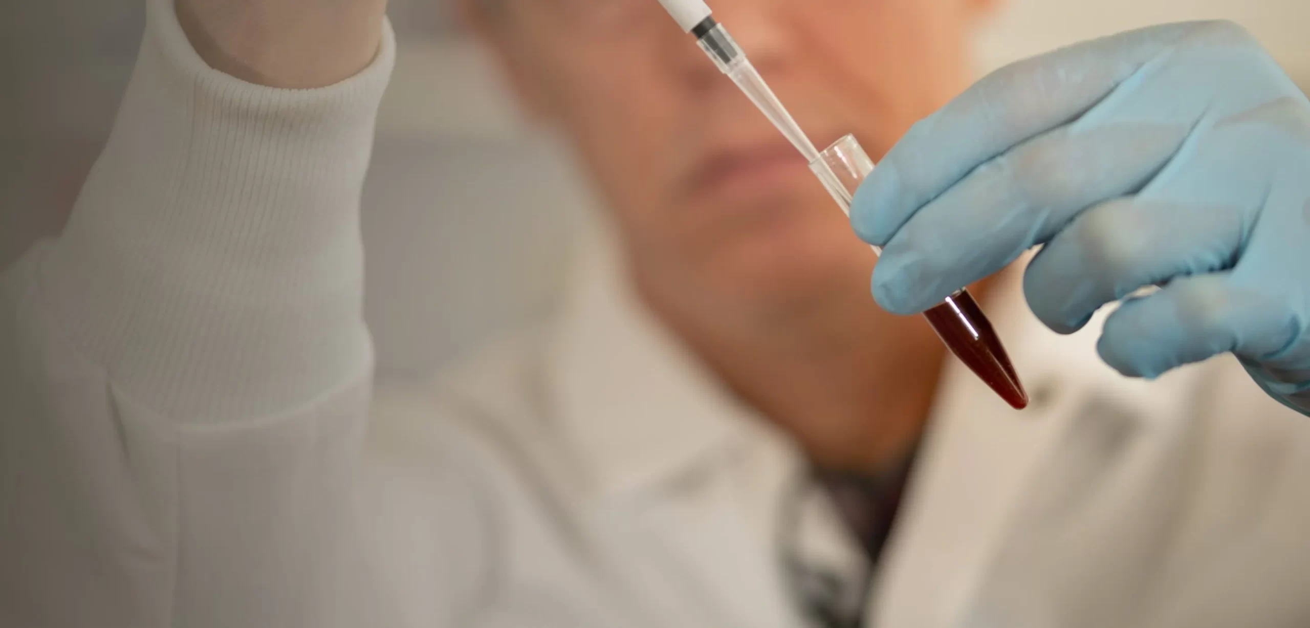 Closeup of person in labcoat working